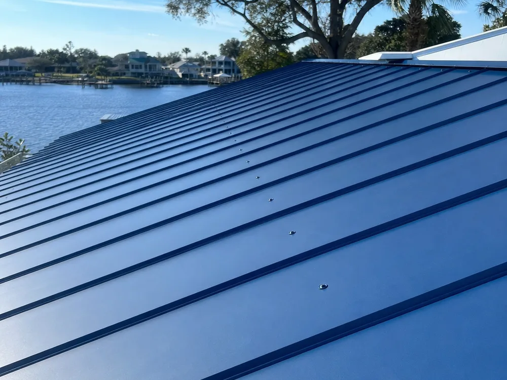 Exposed-fastener roof showing consistent screw lines, correct washer compression, and aligned panel ribs